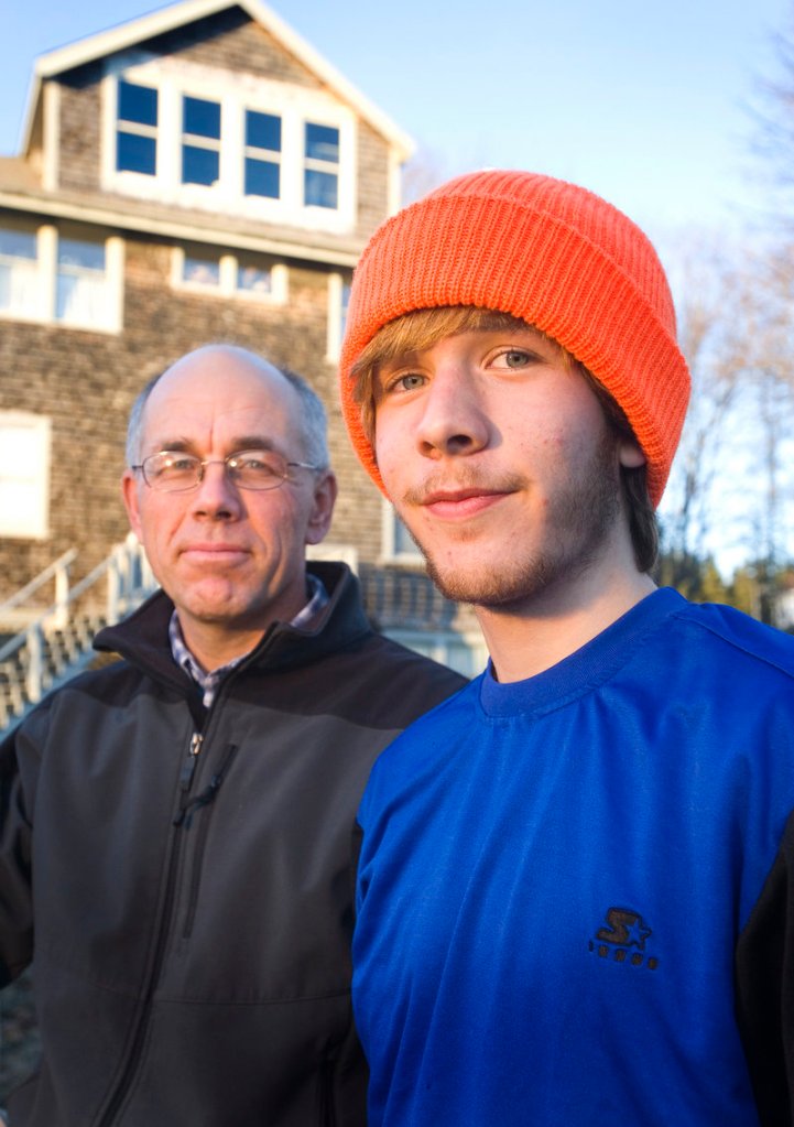 Charlie Jones, a senior, trains with his father, Ken, left, a teacher and coach at the school.