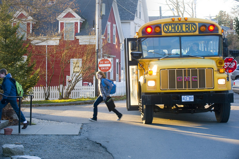 A school bus drops off students at the Waterman's Community Center after school.