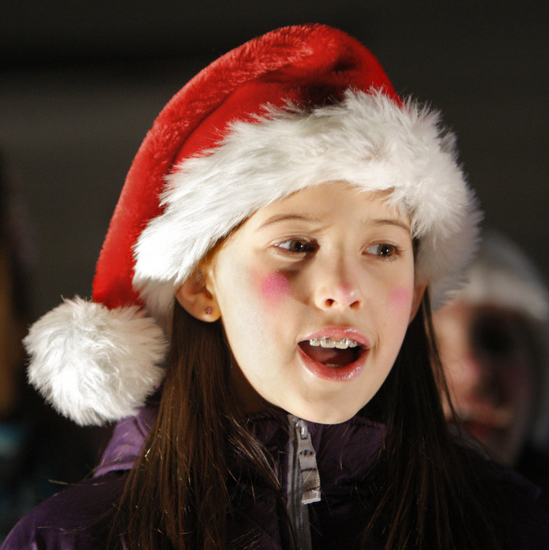 Calliope Landgrebe, 10, of Arundel sings a Christmas carol during Christmas Prelude in Kennebunkport on Friday. She and other children from the Academy of Developing Artists of Maine sang carols before the tree lighting ceremony in Dock Square.