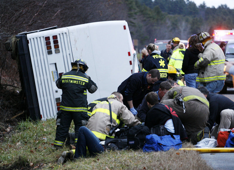 Emergency workers respond to a bus rollover on Friday in Putney, Vt. The bus was carrying a group of UMass students and others to a ski weekend in Quebec. Seventeen people were hurt, including the driver. It’s unclear how the crash occurred, authorities said.