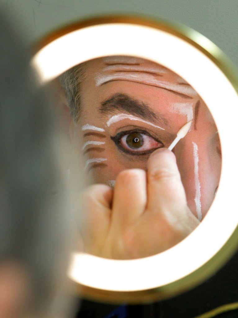 James Herrera applies makeup before taking the stage as Drosselmeyer. The hugely popular show combines the work of hundreds of performers and production staff.