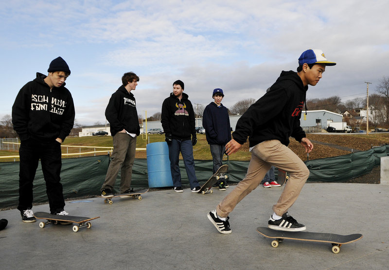 Phivann Phum 19, of Portland takes off into the skatepark as other riders look on.