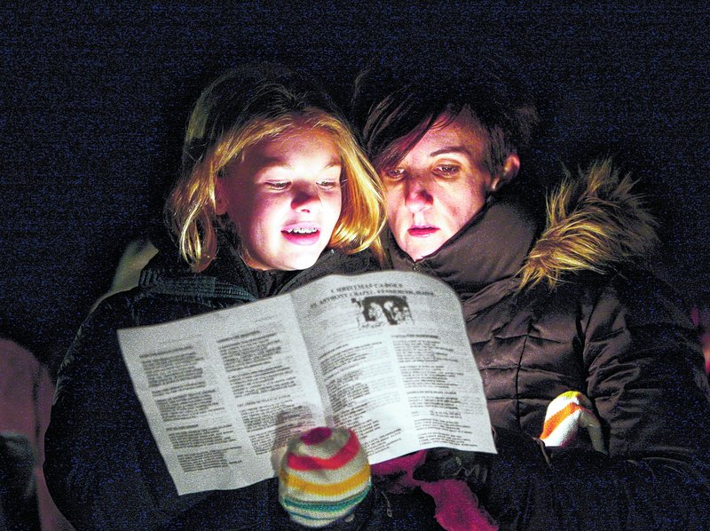 Amy Catling of York, right, and her daughter Brittany sing “It Came Upon a Midnight Clear” at the Franciscan Monastery in Kennebunk on Saturday night.