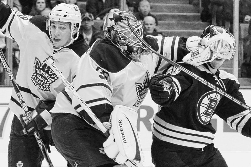 Toronto goalie Jean-Sebastien Giguere blocks Boston’s Blake Wheeler as Keith Aulie battles for the puck behind Giguere. Giguere made a key stop in the shootout to give the Maple Leafs a win over the Bruins on Saturday.