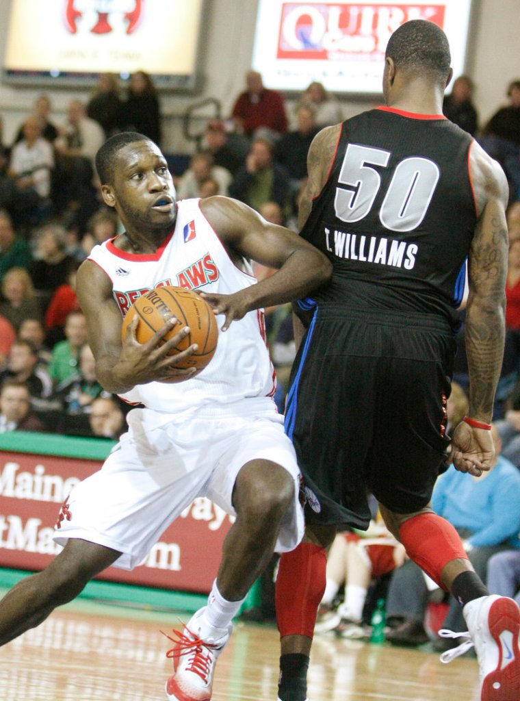 Champ Oguchi of the Red Claws drives past Terrence Williams of the Armor in the third quarter Sunday at the Portland Expo. Oguchi scored 16 points, joining five other Maine players in double-digit scoring.