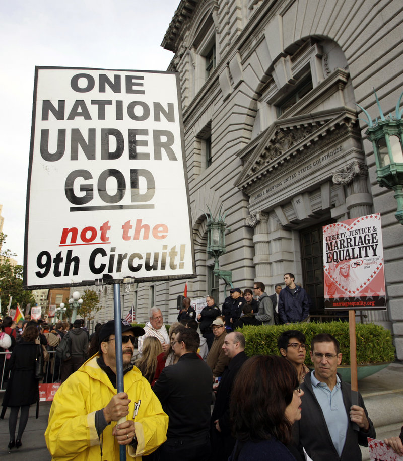 Steve Harris carries a protest sign Monday before a hearing on gay marriage at the Ninth Circuit Court of Appeals in San Francisco. The federal court is considering a trial judge’s decision to overturn the voter-approved ban known as Proposition 8.