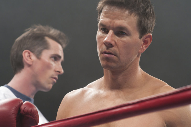 Christian Bale, left, and Mark Wahlberg play half brothers bound by their lives in the ring in “The Fighter.”