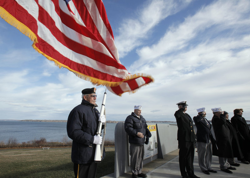 Bill Kiley, left, stands at attention at the start of a ceremony at Fort Allen Park in Portland on Tuesday, an event marking the Dec. 7, 1941 attack on Pearl Harbor. The ceremony was hosted by Amvets, Post #25 in Portland.