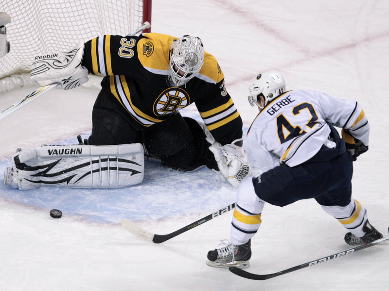 Bruins goalie Tim Thomas makes a pad save on a shot by former Portland Pirate Nathan Gerbe of the Sabres Tuesday night during Boston’s 3-2 overtime victory. The winning goal came with the Bruins on a power play.