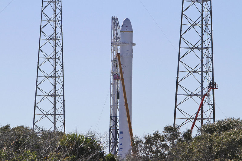 SpaceX’s Falcon 9 rocket, shown Tuesday at Cape Canaveral, Fla., could blast off as early as today. If all goes as planned, the unmanned capsule it propels into orbit will circle the Earth twice, re-enter the atmosphere and splash down in the Pacific Ocean.
