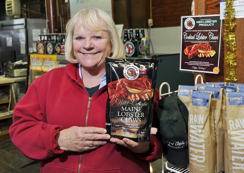 Linda Bean, granddaughter of L.L. Bean, displays a bag of her company’s frozen cooked lobster claws at the Port Clyde General Store. The claws, which sell there for $7.99 a pound, will be available at Walmart stores under the terms of a deal announced last month.