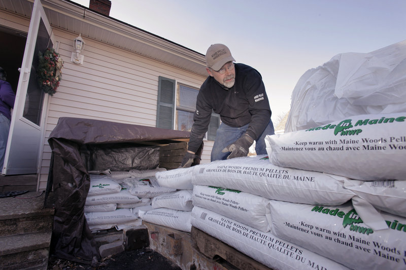 Steve Barker unloads wood pellets from his trailer Wednesday at a home in Portland. Barker and another driver are on the road daily delivering pellets from Kittery to the Bangor area.