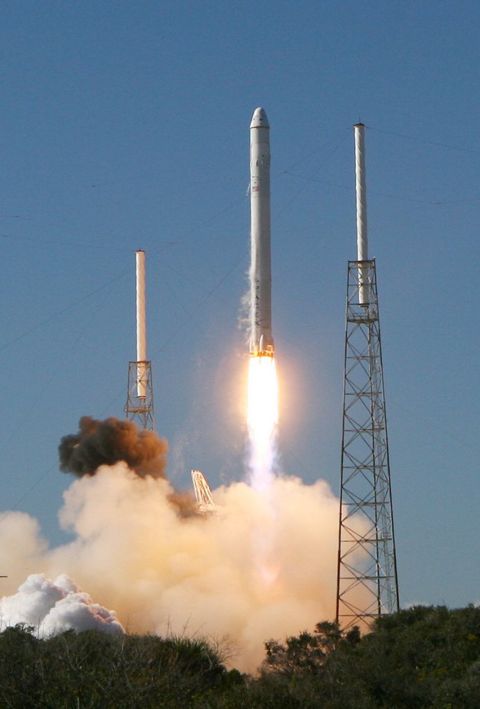 A Falcon 9 rocket built by SpaceX blasts off from Cape Canaveral, Fla., carrying an unmanned Dragon capsule 187 miles into space orbit.