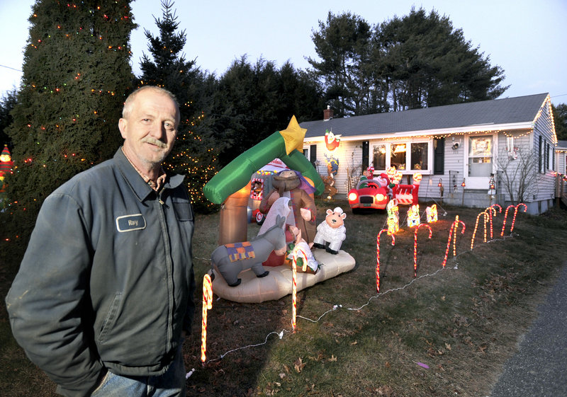 Ray Benner shows off his collection of inflatable holiday decorations at his home on Austin Street in Westbrook.