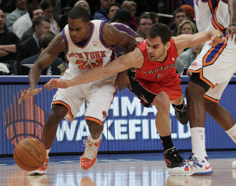 Toney Douglas, left, of the Knicks battles Toronto’s Jose Calderon for a loose ball Wednesday night during New York’s 113-100 victory, its sixth in a row.