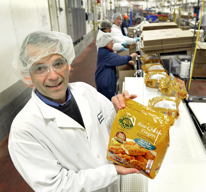 David Barber, executive vice president of Barber Foods, holds a bag of chicken fingers at the Portland plant.