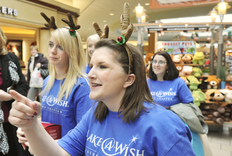Nicole Guerrette, accompanied by her mother, sister and cousin, gets to the business at hand Friday: a shop-a-thon at the Maine Mall, courtesy of the Make-A-Wish Foundation.