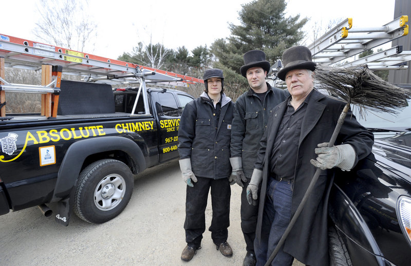 Zandy Talmage, right, and his sons Max, left, and Eben operate Absolute Chimney Service in Kennebunkport. The master sweep on any given day wears a top hat and topcoat like the chimney sweeps in old England did.