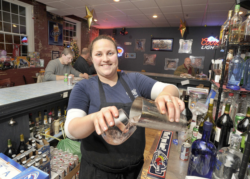 Bartender Jenn Larochelle mixes drinks at the Union House Pub & Pizza, which started as a coffee shop but changed its niche when the owners realized how popular the place was during lunch and after work.