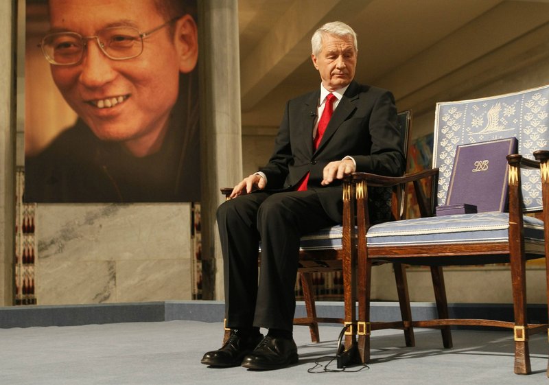 Thorbjoern Jagland, chairman of the Nobel Committee, sits next to the diploma and medal on an empty chair that symbolizes the imprisonment of peace-prize winner and activist Liu Xiaobo during a ceremony in Oslo on Friday.