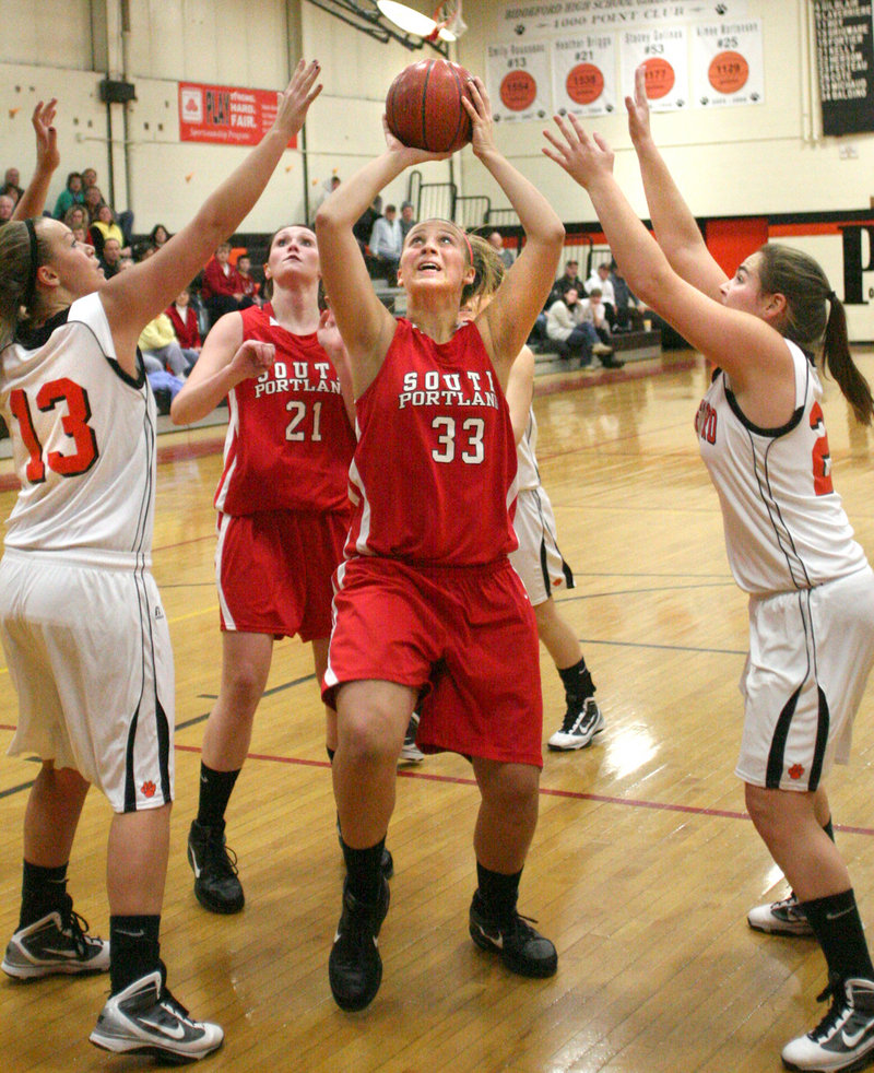 Abby Hasson of South Portland eyes the basket as she goes up for a shot Friday night against Biddeford. Hasson had 19 points to lead the Red Riots past Biddeford, 72-55.