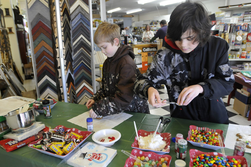 Hunter Maggs, 9, and his brother Coulton Maggs, 12, of Hollis have a number of sweet decorations to adorn the gingerbread men they’re making at Sam’s Place in Saco.