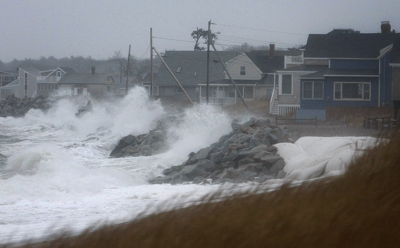 Waves break along Camp Ellis in Saco on Sunday, when a storm brought black ice to parts of Maine.