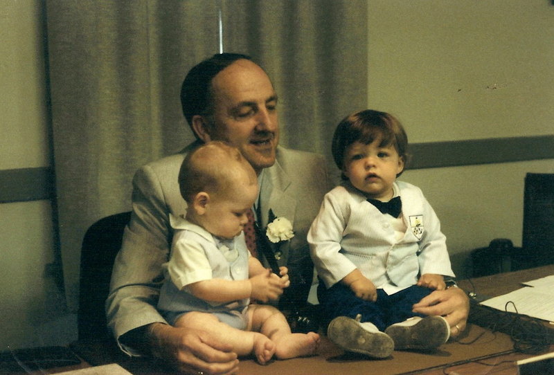 Ralph D. Howard holds grandsons Trevor Howard Michaelson, 6 months, and Howard Clark, 11 months, in 1987.