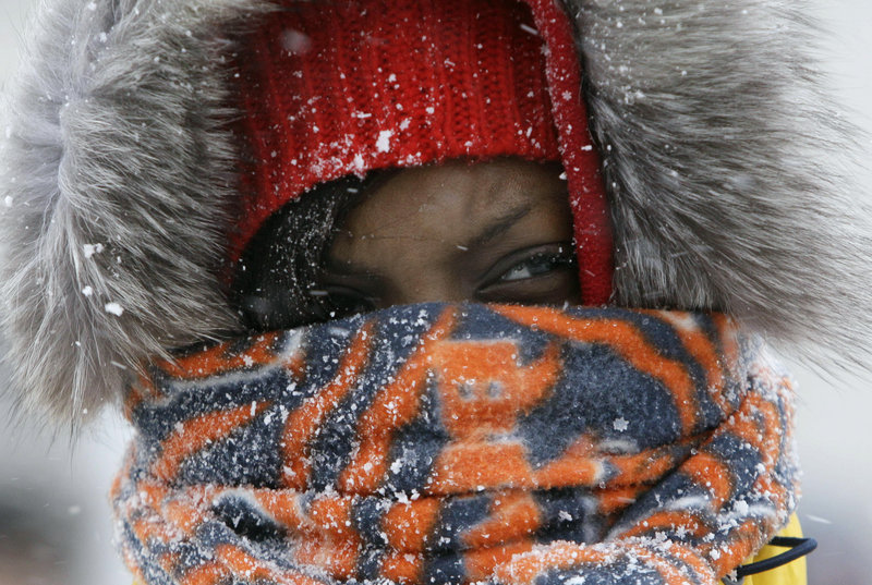 Chicago Bears fan Janise Ford arrives bundled up at Chicago’s Soldier Field before the Bears and New England Patriots played a blustery game there on Sunday.