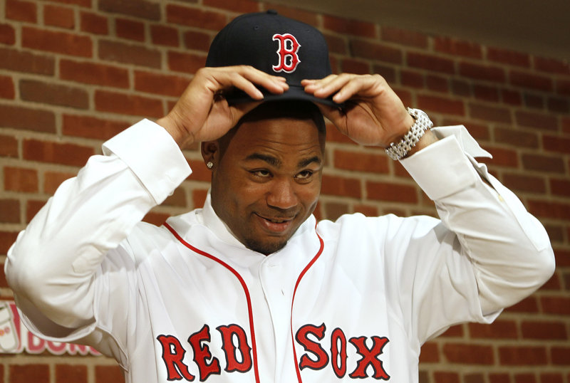 Carl Crawford, trying on his new Boston hat at a press conference Saturday, is a speedy .300 hitter who just might lead the American League in runs scored this year.