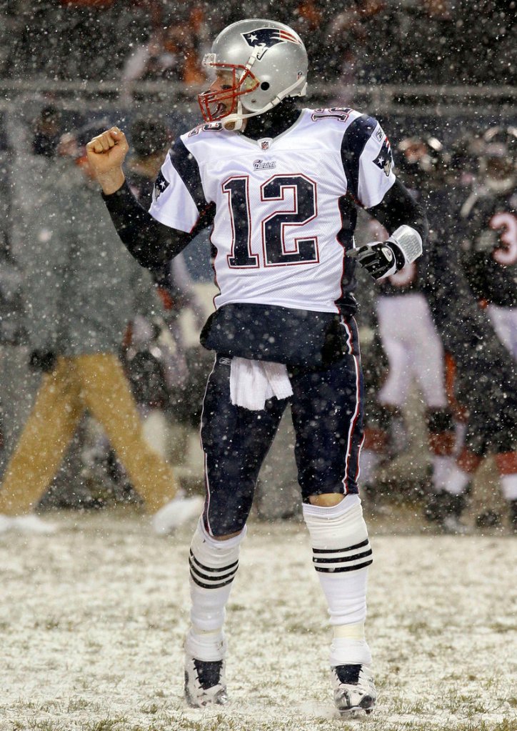 Tom Brady reacts after throwing one of his two first-half touchdown passes Sunday at snowy Soldier Field in Chicago. He hit Rob Gronkowski on a 7-yard strike and Deion Branch on a 59-yarder.