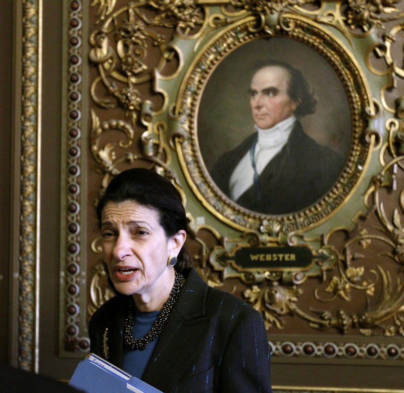Sen. Olympia Snowe, R-Maine, talks with a reporter during a procedural vote Monday on President Obama’s tax-cut bill. She voted in favor of the package.