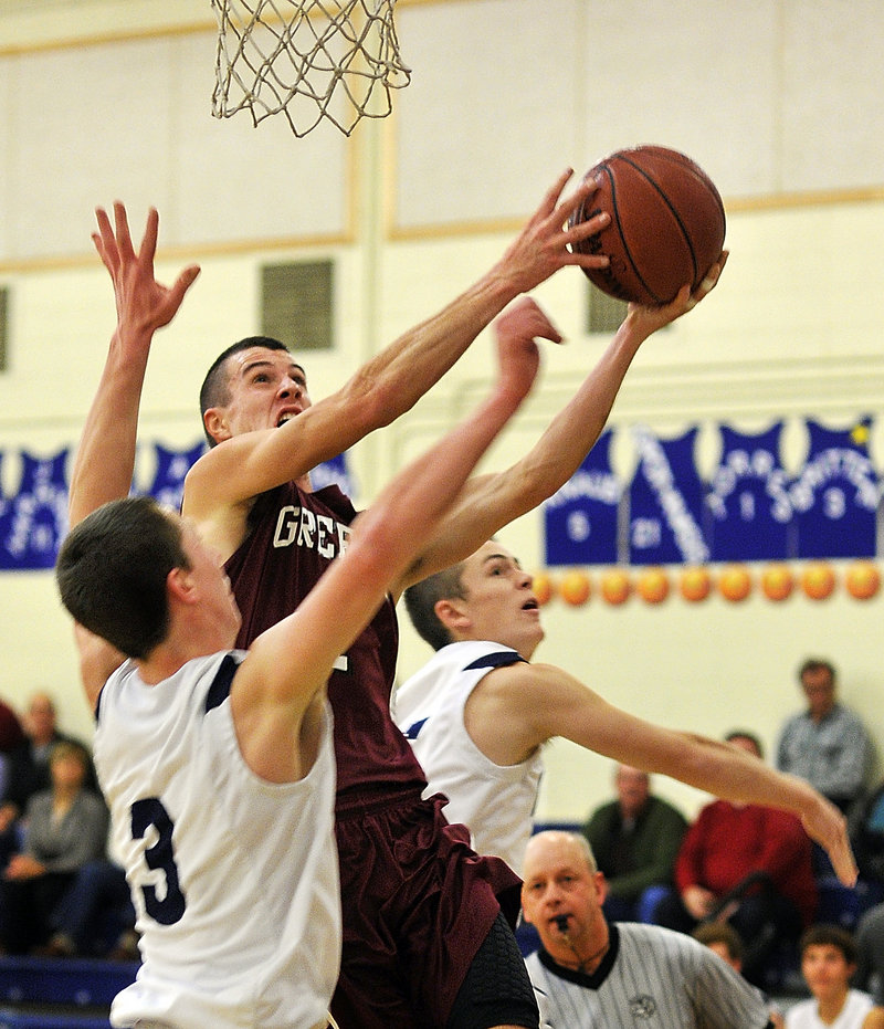 Sam Johnston, who led a balanced Greely attack with 12 points, drives to the basket against Yarmouth defenders Josh Britten, left, and Sam Torres. The visiting Rangers improved to 2-0, while cold-shooting Yarmouth fell to 1-1.