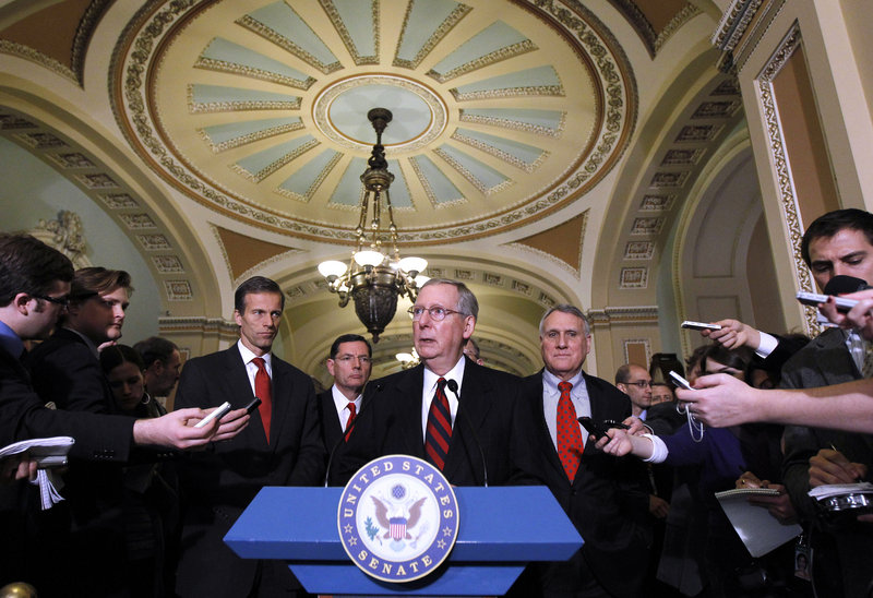 Senate Minority Leader Mitch McConnell, R-Ky., talks with reporters on Capitol Hill Tuesday about the bill that would extend the Bush tax cuts. Seen with McConnell are Sen. John Barrasso, R-Wyo., left, and Sen. Jon Kyl, R-Ariz., right.