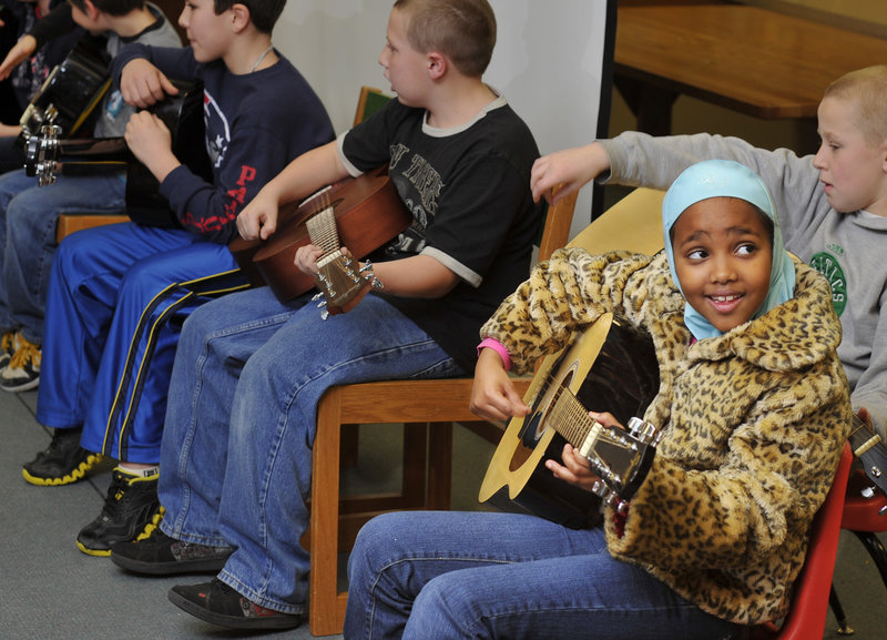 Fourth-grader Nimco Aden, 9, plays with the guitar club.