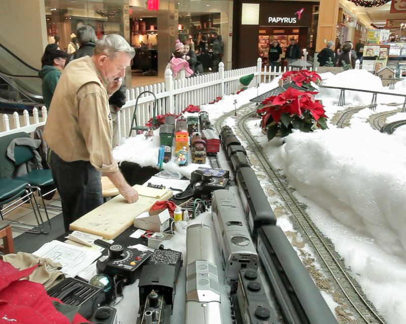 Carl Churchill of Buxton runs trains at the Maine Mall. In the summer, Churchill and his wife, Patricia, regularly invite veterans' home residents to view their backyard train setup.