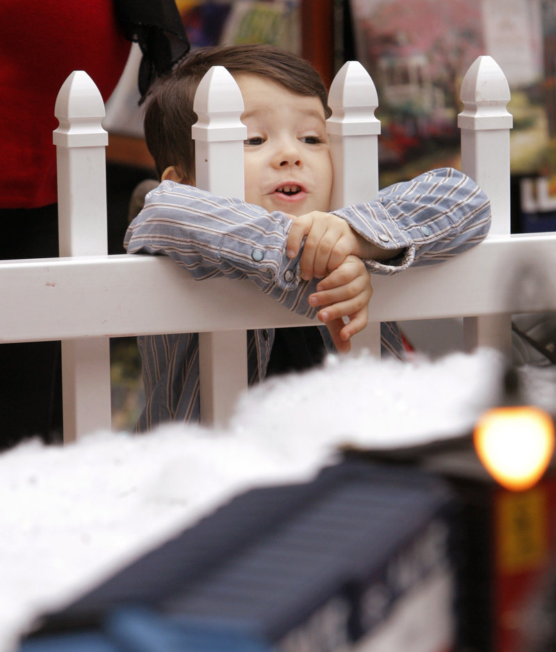 Phillip John Smith, 3, of Scarborough watches a train pass by at the Garden Railway Society of Maine’s first Christmas display at the mall. The society, started nine years ago by Carl Churchill of Buxton, has 140 members.