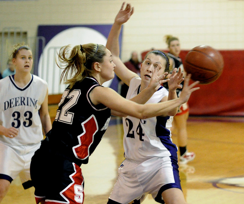 Emily Howes of Scarborough gets away a pass despite pressure from Deering's Ella Ramonas during a game Friday night at Deering High. The Rams took control early and improved to 3-0 with a 68-33 victory.