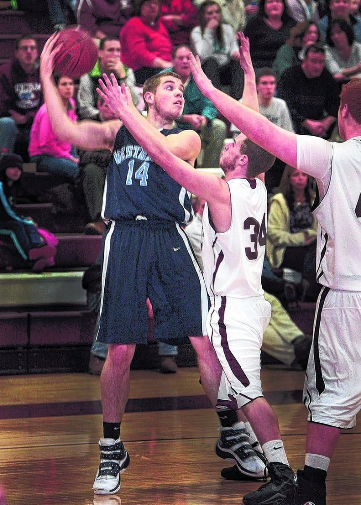 Sean Murphy, who scored 30 points Friday night for Westbrook, including 21 in the opening quarter, looks to pass as Kyle Williams of Windham defends in the third quarter of Westbrook s 61-50 victory at Windham.