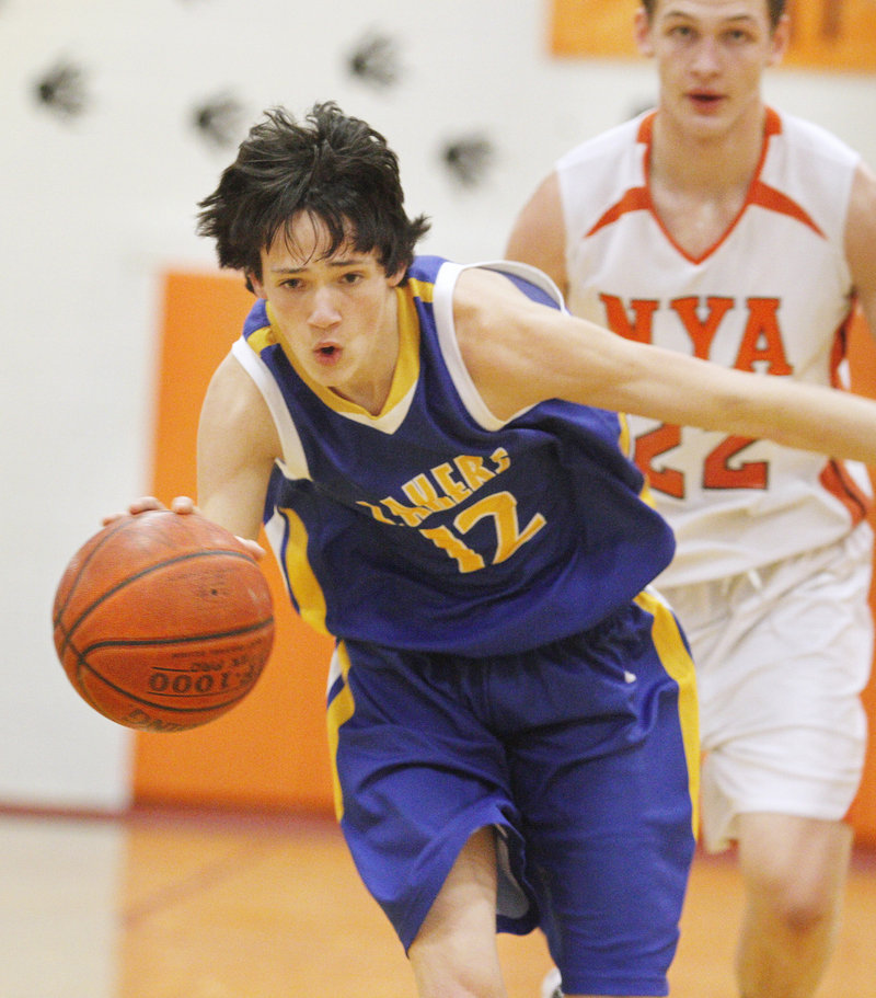 Alex Hartford, who scored 28 points for Lake Region, races up the floor ahead of Andrew Esancy of NYA.