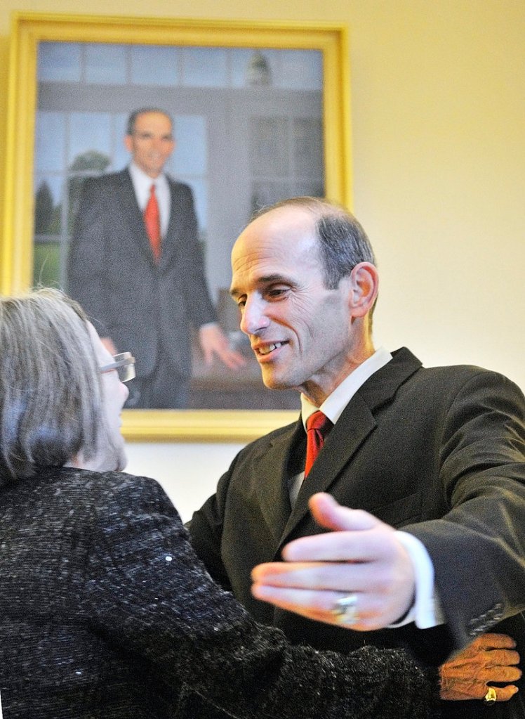 Artist Jean Pilk, left, gets a hug from Gov. John Baldacci after her portrait of him was unveiled during ceremonies in the State House on Saturday afternoon in Augusta. The oil painting is the 141st work of art to be hung permanently in the state Capitol, according to the officials at the Maine State Museum.