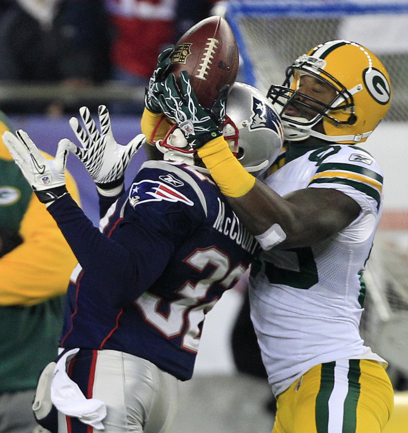 New England cornerback Devin McCourty, left, breaks up a pass intended for Packers receiver James Jones in the first half. Jones had 5 catches for 95 yards, including a 66-yard TD catch in the second quarter for a 10-7 lead.