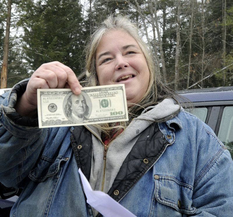 Patricia Ange at the Warming Hut in Sebago, with the contents of her envelope from Secret Santa.