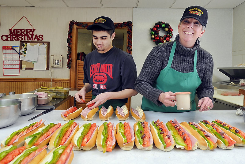 John and Jean Ladakakos make hundreds of Italian sandwiches a day for customers at George’s Sandwich Shop in Biddeford.