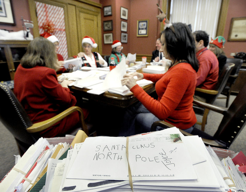 Postal workers sort Dear Santa letters Wednesday at the post office on Forest Avenue in Portland.