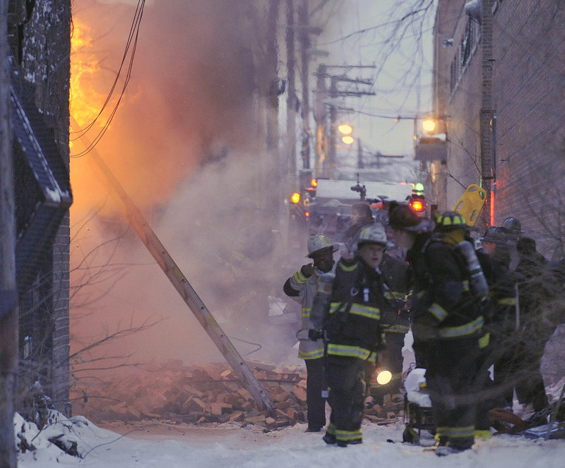 Chicago firefighters battle a blaze Wednesday at an abandoned building on the city’s South Side. What was expected to be a routine winter fire left two firefighters dead after the roof and a wall collapsed.