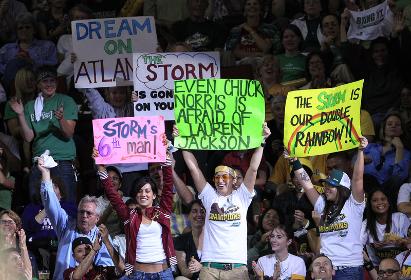 Seattle Storm fans cheer on their WNBA team against the Atlanta Dream last fall. Women’s sports get much less attention than men’s; experts aren’t sure why that is.