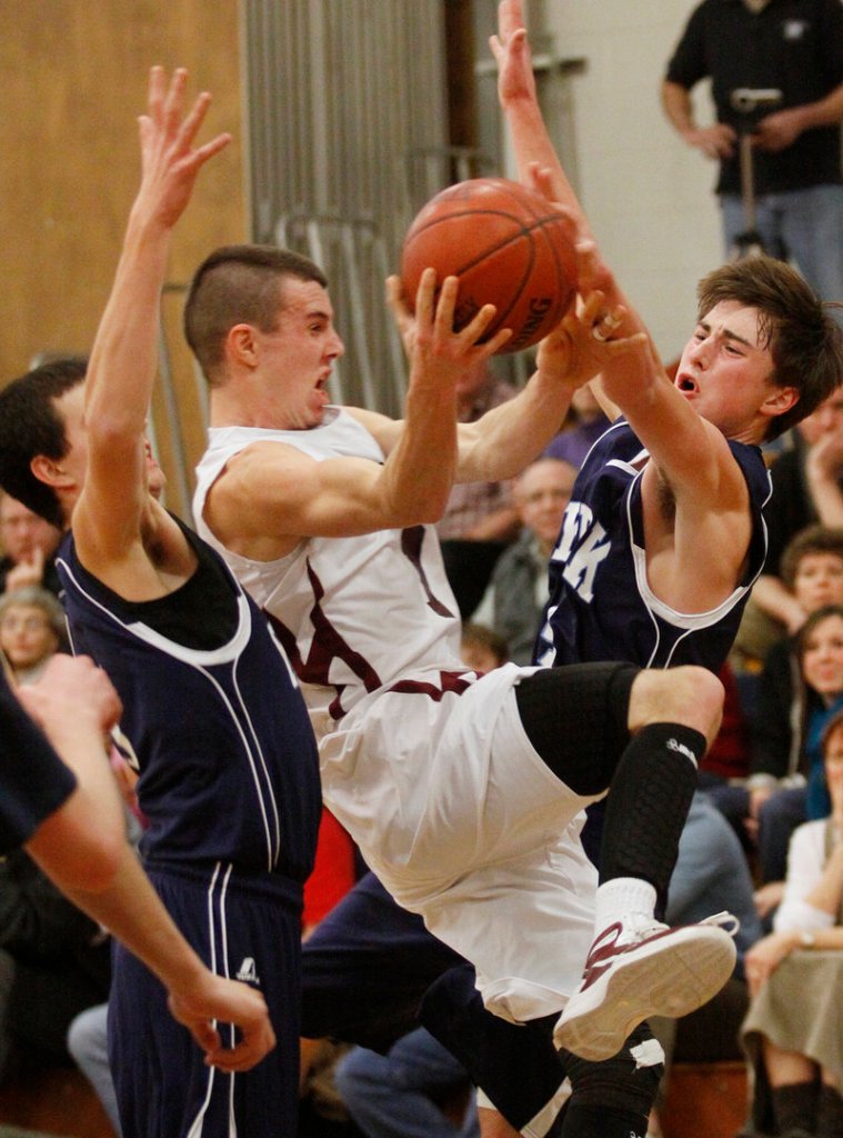 Sam Johnston, who scored 29 points Thursday night for Greely in a 67-49 victory against York, is fouled by Liam Langaas, right, while on a drive. The Rangers reached 6-0 and dropped the Wildcats to 4-2.