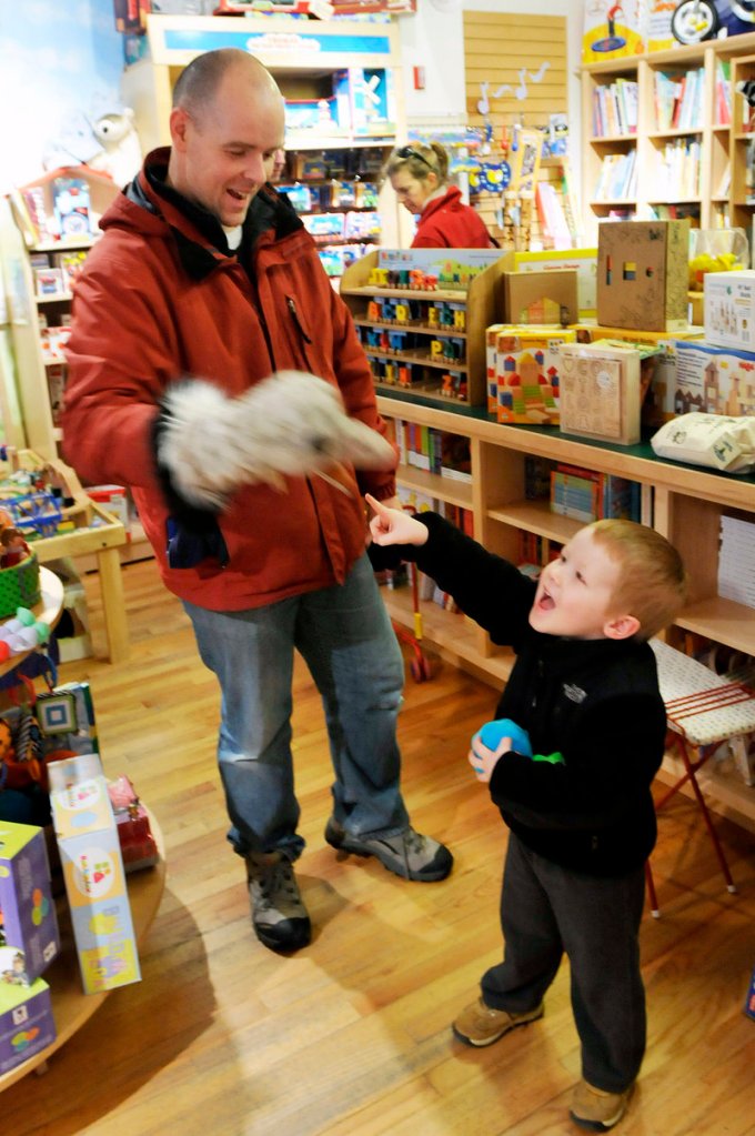 Sean Lyons of Freeport tries out a puppet with his son Nathaniel, 3, at Treehouse Toys. The duo hoped to find the perfect gift for Nathaniel’s 9-month-old sister.
