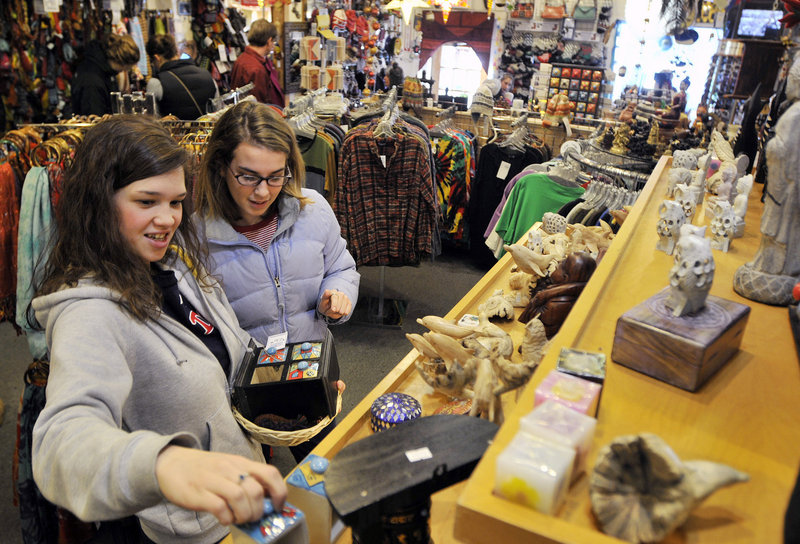 Lynsie Peters and Elise Alves, both of Portland, browse at Mexicali Blues in the Old Port on Friday. “I want to take as long as possible to find the perfect gift,” Alves said.